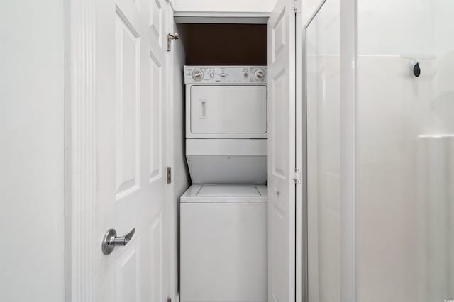 clothes washing area with stacked washer and clothes dryer