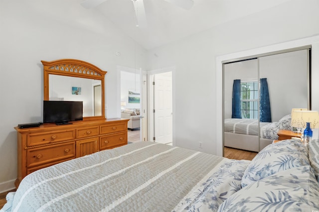 bedroom featuring light hardwood / wood-style flooring, a closet, high vaulted ceiling, and ceiling fan