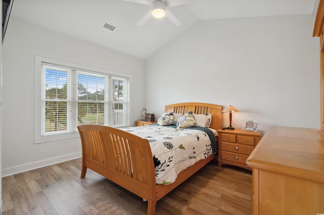 bedroom featuring ceiling fan, hardwood / wood-style flooring, and vaulted ceiling