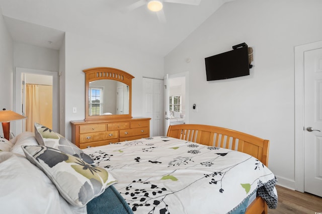 bedroom featuring ceiling fan, wood-type flooring, and vaulted ceiling