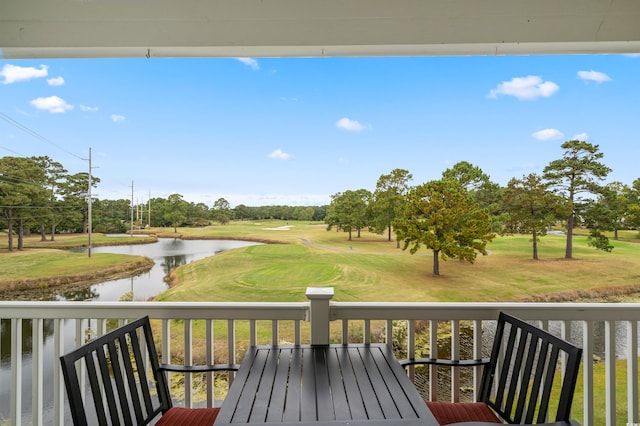 wooden deck featuring a water view and a yard