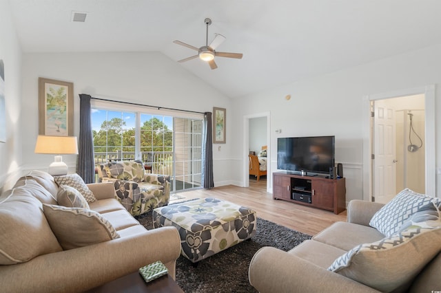 living room featuring vaulted ceiling, light hardwood / wood-style floors, and ceiling fan