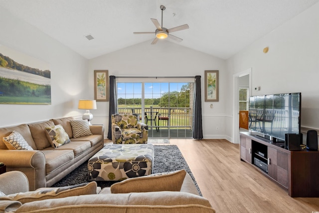 living room with ceiling fan, light wood-type flooring, and vaulted ceiling