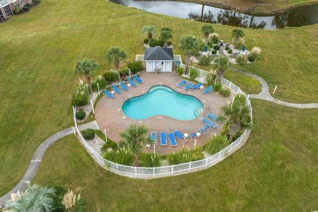 view of swimming pool featuring a patio area, a yard, and a water view