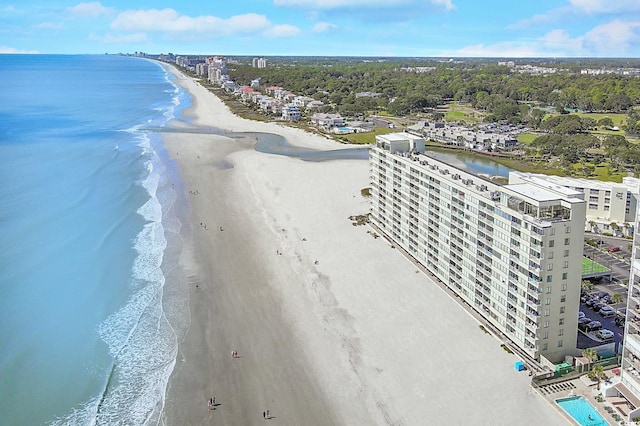 birds eye view of property featuring a water view and a beach view