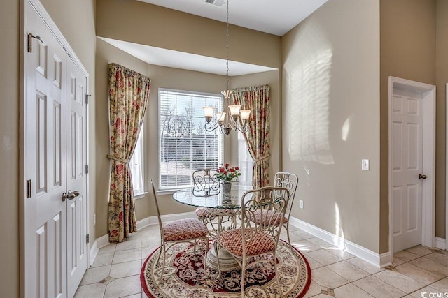 dining room featuring an inviting chandelier, baseboards, and light tile patterned floors