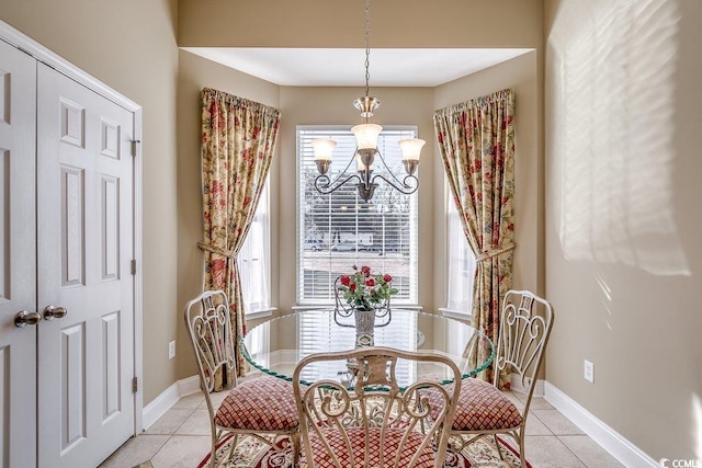 dining room featuring baseboards, a notable chandelier, and light tile patterned floors