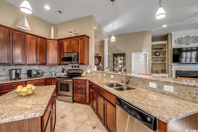 kitchen featuring appliances with stainless steel finishes, a sink, tasteful backsplash, ornate columns, and visible vents