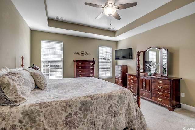 bedroom with visible vents, baseboards, ceiling fan, and light colored carpet