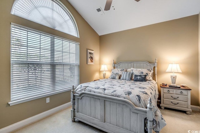 bedroom with light colored carpet, baseboards, and high vaulted ceiling