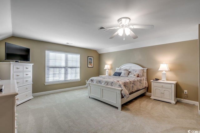 bedroom with light colored carpet, baseboards, and vaulted ceiling