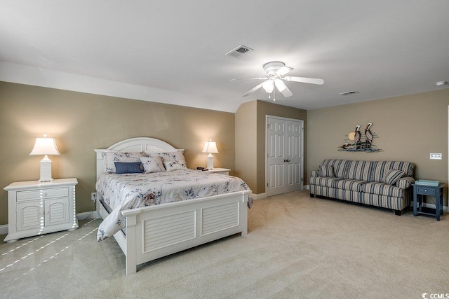 carpeted bedroom with baseboards, visible vents, ceiling fan, and a closet