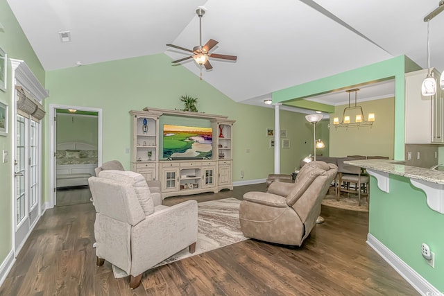 living room featuring visible vents, dark wood-type flooring, ceiling fan with notable chandelier, baseboards, and vaulted ceiling