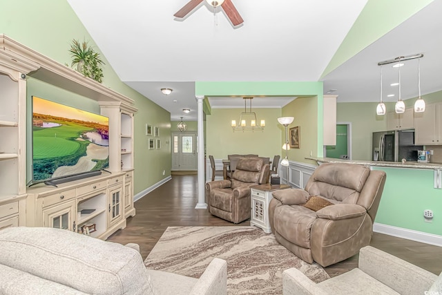 living room with crown molding, decorative columns, vaulted ceiling, ceiling fan with notable chandelier, and wood finished floors