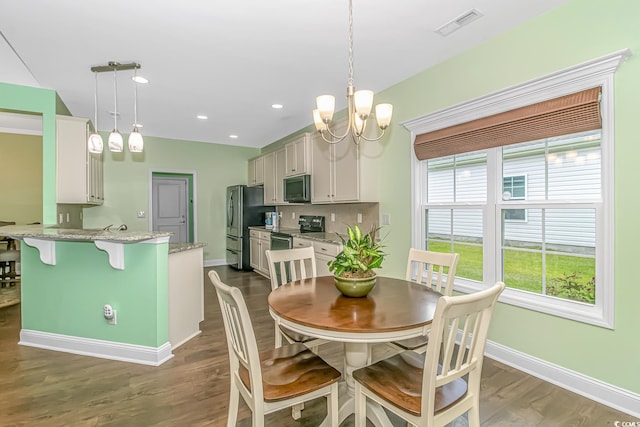 dining space featuring visible vents, dark wood finished floors, recessed lighting, baseboards, and a chandelier