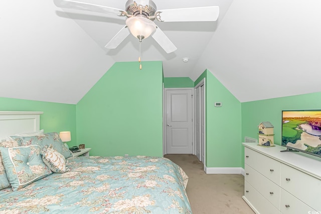 bedroom with light colored carpet, baseboards, ceiling fan, and vaulted ceiling