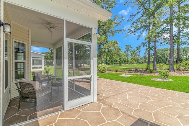 view of patio / terrace with a sunroom and ceiling fan