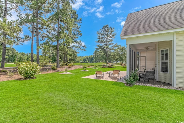 view of yard featuring a patio area and ceiling fan