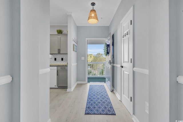 interior space with ornamental molding and light hardwood / wood-style flooring