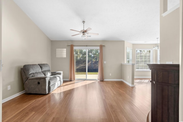 sitting room featuring plenty of natural light, light wood-style flooring, and baseboards