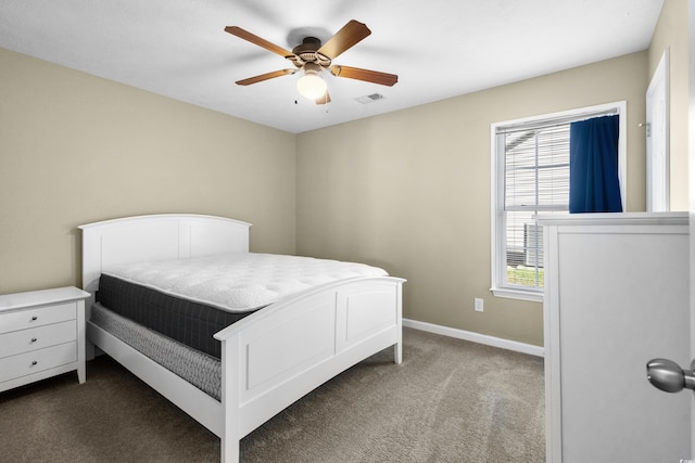 carpeted bedroom with a ceiling fan, visible vents, and baseboards