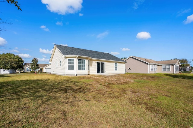 rear view of house with a yard