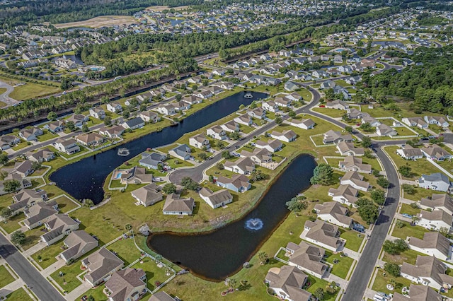 drone / aerial view featuring a water view and a residential view