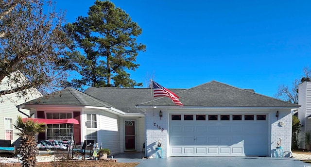 2169 Wedgewood Dr, Longs, SC 29568 - view of front facade with brick siding, an attached garage, driveway, and a shingled roof