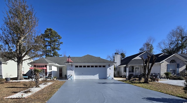 single story home featuring a garage and concrete driveway