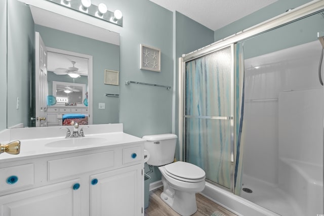 2169 Wedgewood Dr, Longs, SC 29568 - ensuite bathroom with a shower stall, wood finished floors, vanity, ceiling fan, and a textured ceiling