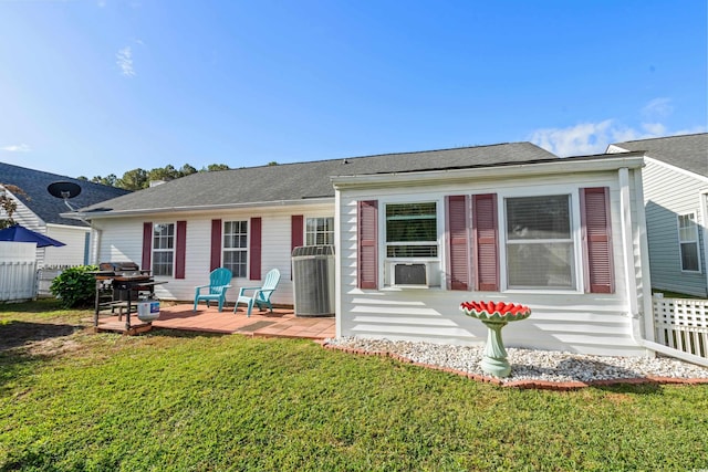 rear view of house featuring cooling unit, a yard, and a wooden deck