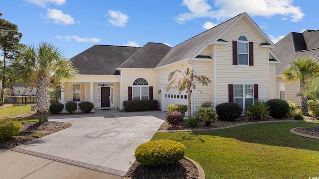 front facade featuring a garage and a front lawn