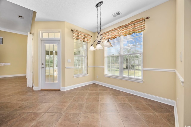 unfurnished dining area featuring a textured ceiling, a chandelier, and light tile patterned floors