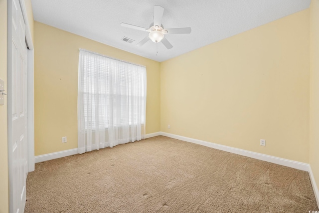 unfurnished room with carpet, a textured ceiling, and ceiling fan