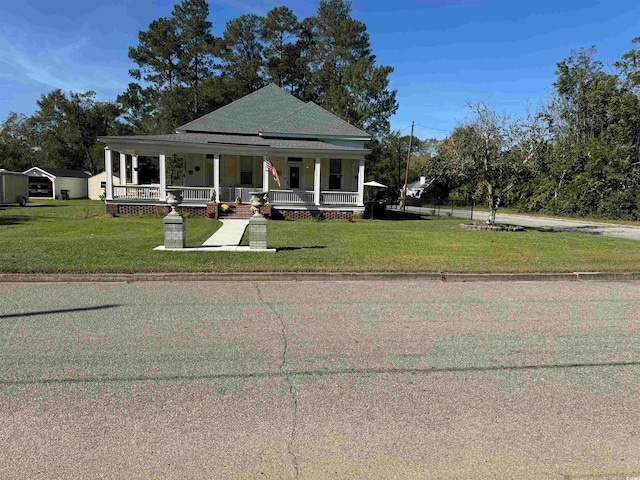 view of front facade with a front lawn and a porch