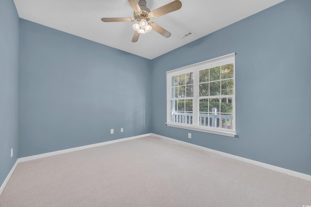 unfurnished room featuring a textured ceiling, carpet floors, and ceiling fan