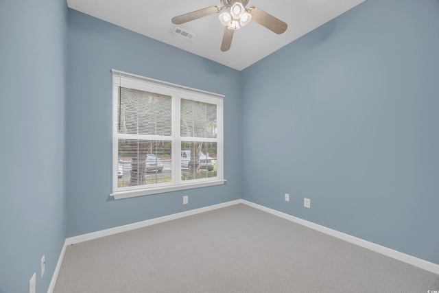 carpeted empty room featuring ceiling fan