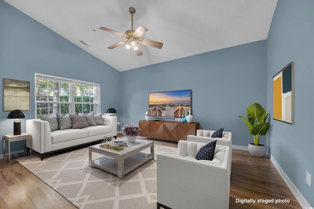 living room with light hardwood / wood-style flooring, high vaulted ceiling, and ceiling fan