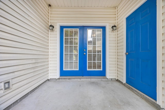 view of exterior entry featuring a patio area