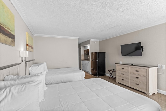 9550 Shore Dr Unit 1202, Myrtle Beach, SC 29572 - bedroom featuring freestanding refrigerator, crown molding, a textured ceiling, wood finished floors, and baseboards