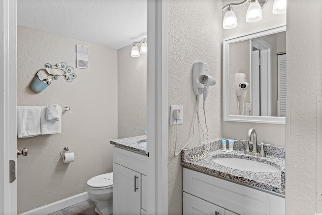9550 Shore Dr Unit 1202, Myrtle Beach, SC 29572 - bathroom featuring vanity, toilet, a textured ceiling, and a textured wall