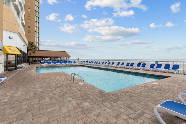 9550 Shore Dr Unit 1202, Myrtle Beach, SC 29572 - community pool with a patio area