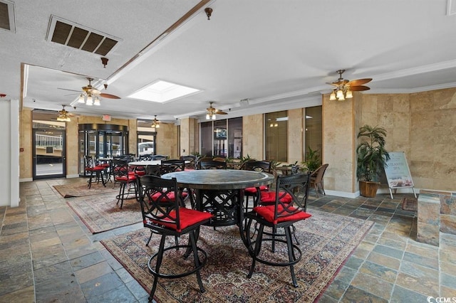 9550 Shore Dr Unit 1202, Myrtle Beach, SC 29572 - dining area with a ceiling fan, stone tile flooring, and crown molding