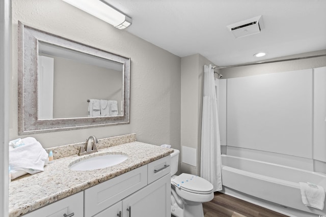 full bathroom with vanity, toilet, shower / bath combo with shower curtain, and hardwood / wood-style floors