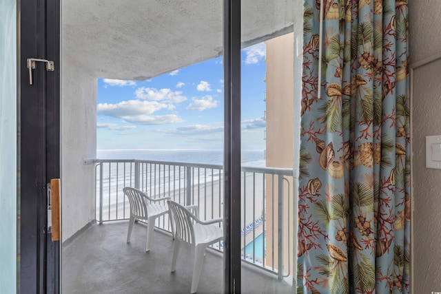 balcony featuring a water view