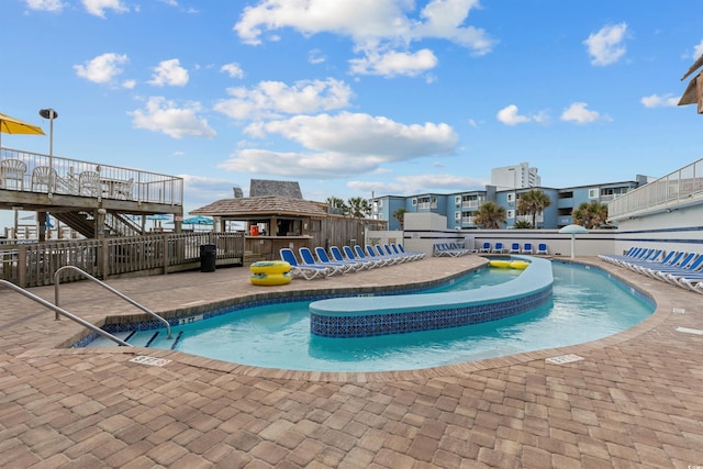 view of swimming pool featuring a patio, a gazebo, and a wooden deck