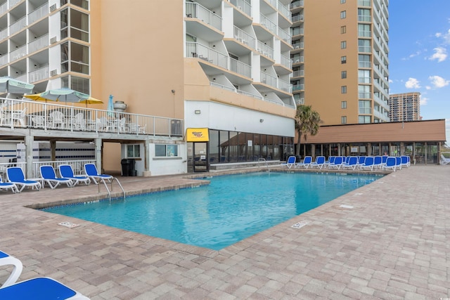 view of swimming pool featuring a patio area