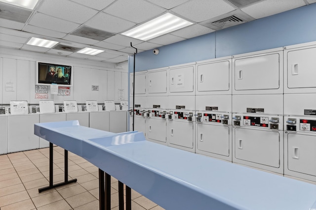 interior space featuring stacked washer and dryer, separate washer and dryer, and light tile patterned flooring