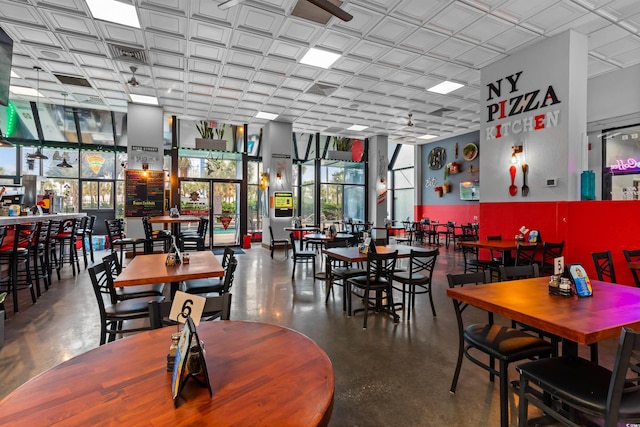 dining room with concrete flooring and ceiling fan