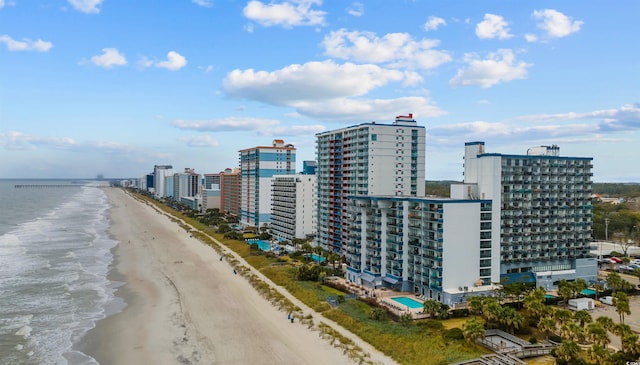 bird's eye view featuring a view of the beach and a water view